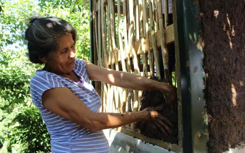 FUNDASAL Woman Building with MUD